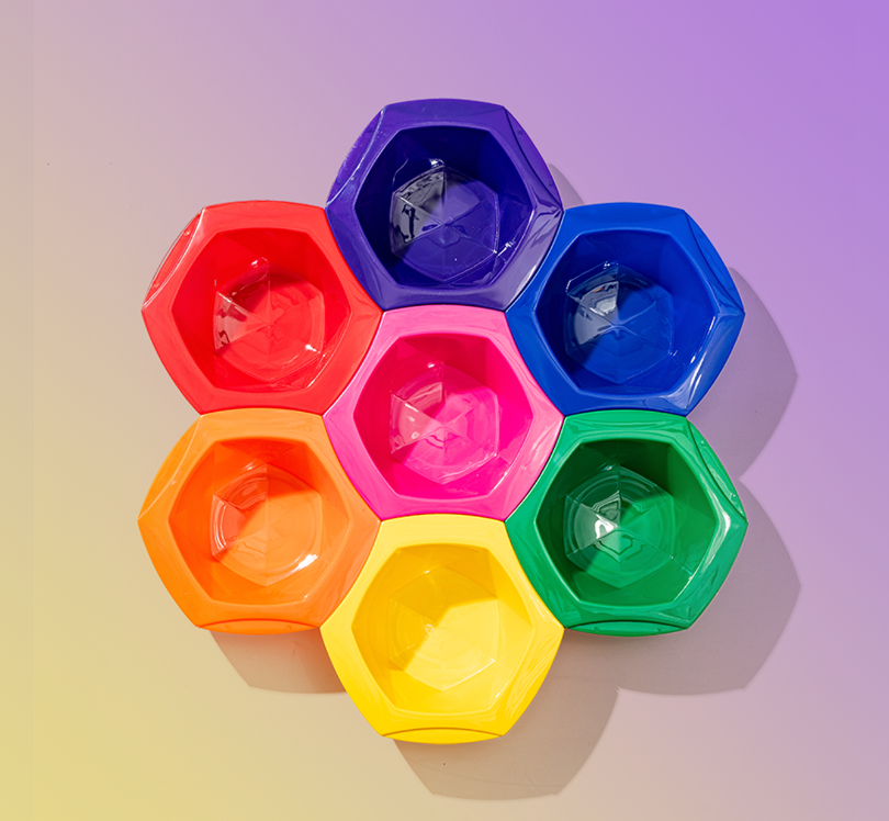 Hexagonal ice cube trays in various colors on a gradient background