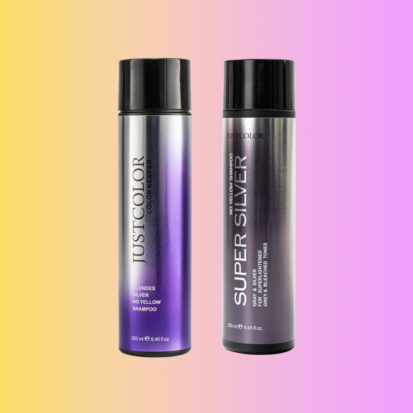 Two bottles of JustColor hair color products on a gradient background